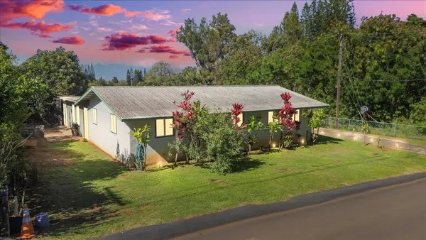 a view of a house with a yard and a garden
