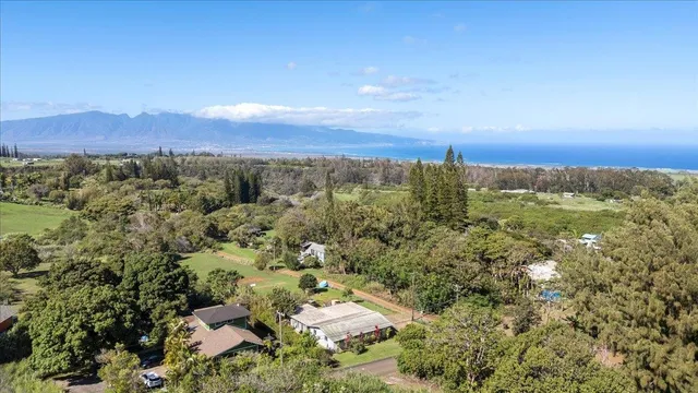 an aerial view of a houses with a yard