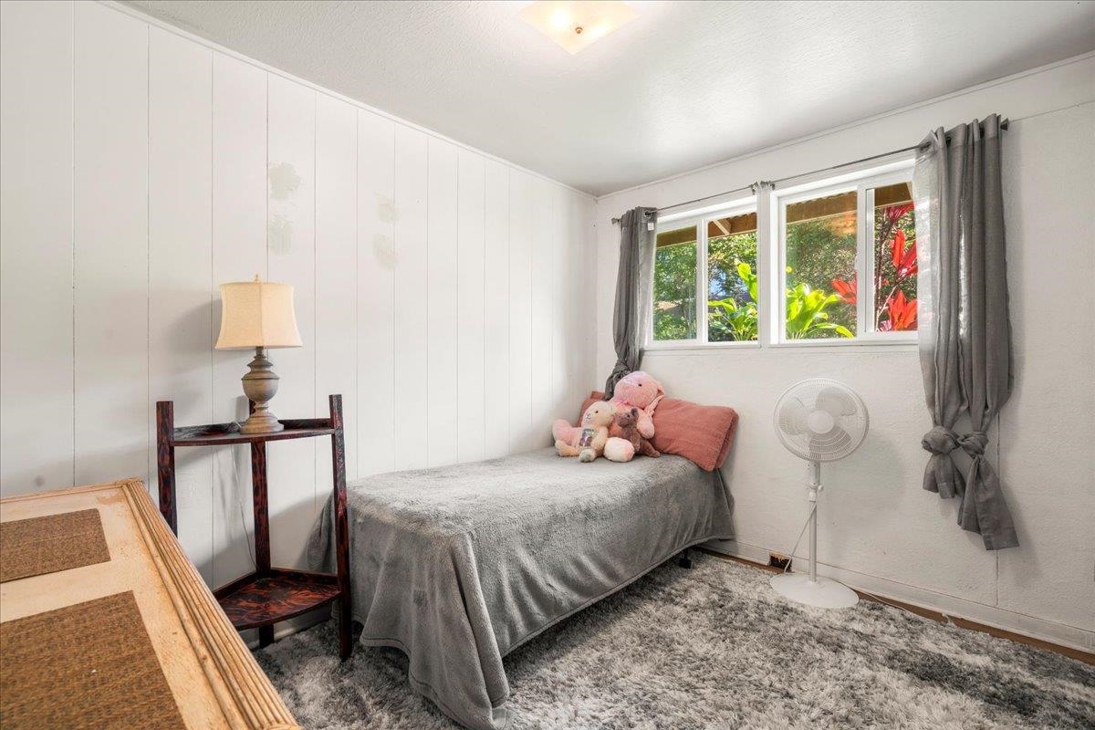 2226 Lilikoi Road Haiku, HI 96708 - Photo 24 of 50 a bedroom with a bed and a window