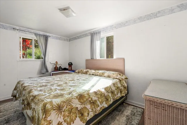 a bedroom with a bed and a mirror