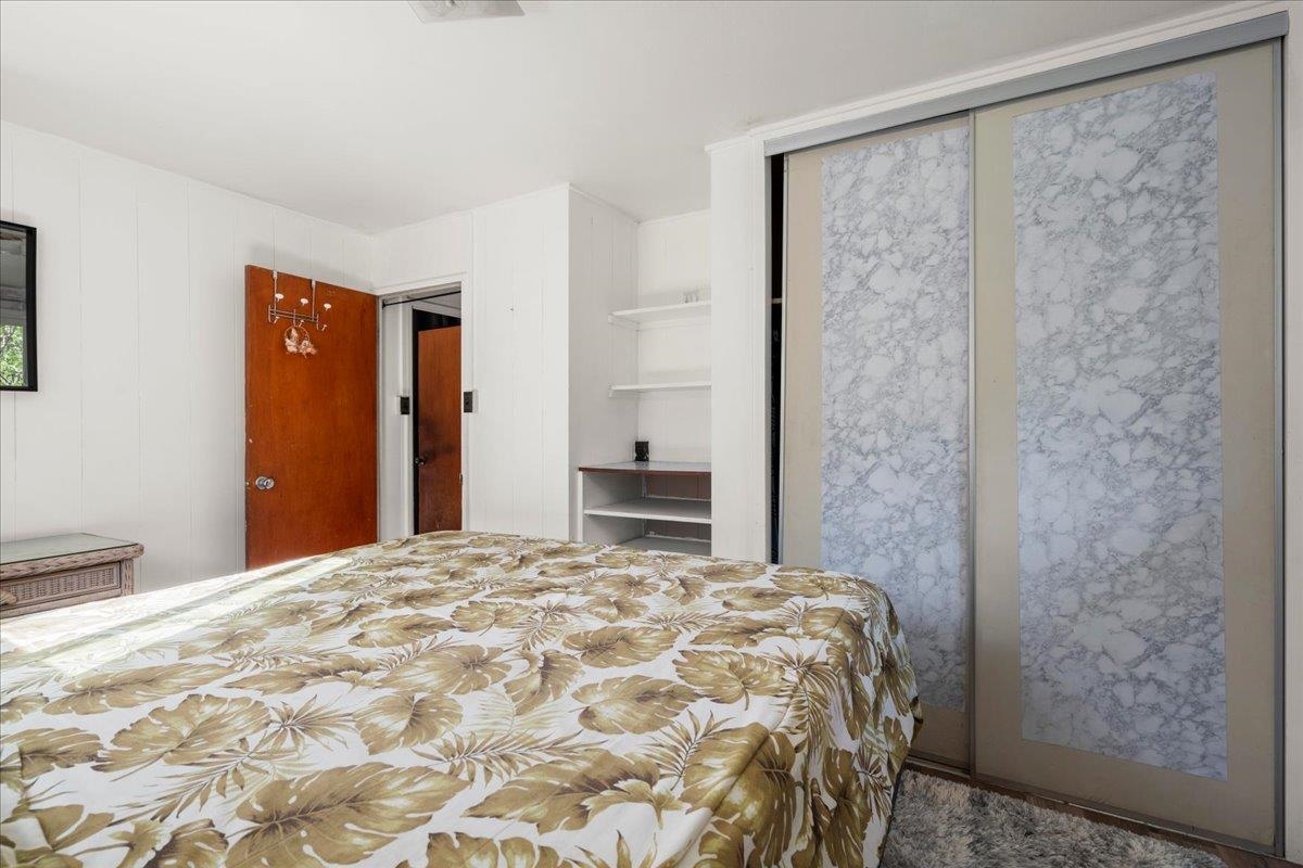 2226 Lilikoi Road Haiku, HI 96708 - Photo 28 of 50 a bedroom with a bed and a mirror