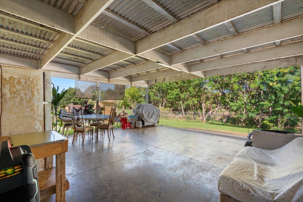 2226 Lilikoi Road Haiku, HI 96708 - Photo 29 of 50 a view of a patio with table and chairs potted plants with wooden floor