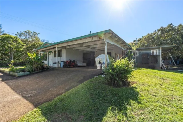a view of a house with backyard and sitting area