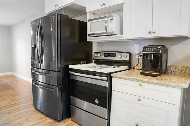 a kitchen with granite countertop stainless steel appliances and wooden cabinets