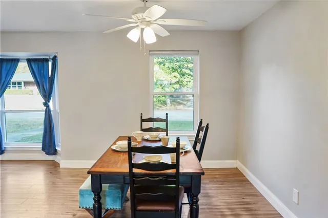 a view of a dining room with furniture window and wooden floor