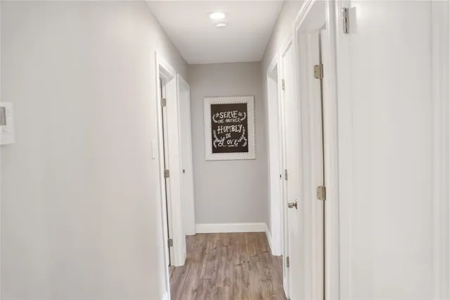a view of a hallway with wooden floor