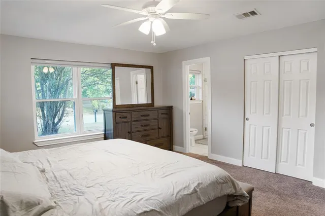 a bedroom with a bed dresser and a window