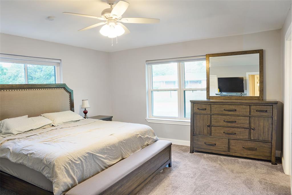 3011 Tanglewood Drive Commerce, TX 75428 - Photo 24 of 40 a bedroom with a bed and a television