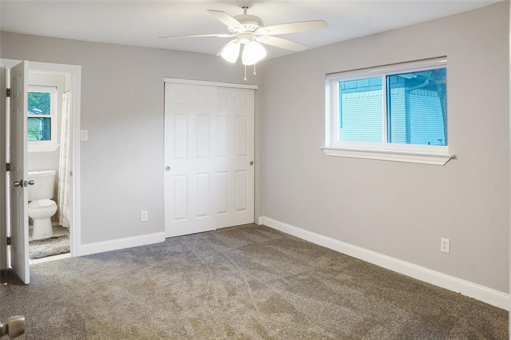 3011 Tanglewood Drive Commerce, TX 75428 - Photo 25 of 40 an empty room with windows and fan