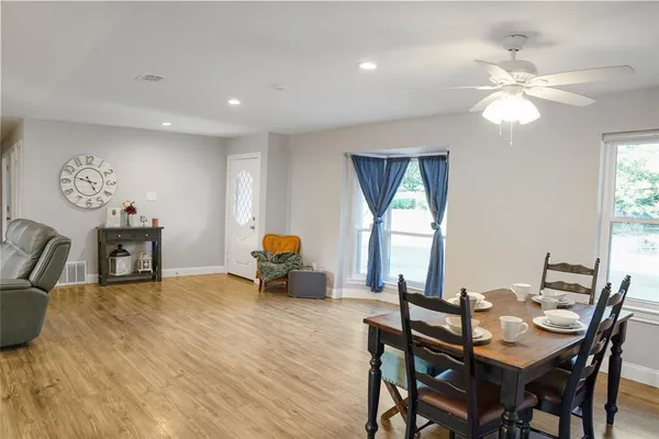 a view of a dining room with furniture and a chandelier