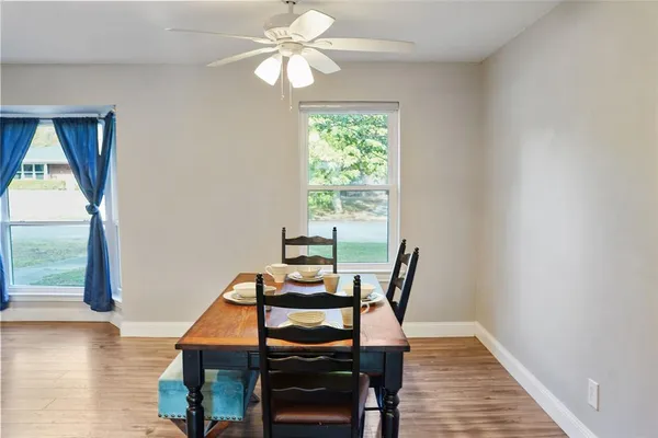 a view of a dining room with furniture window and wooden floor