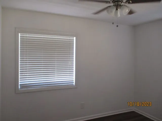 a view of a room that has a window and a fan