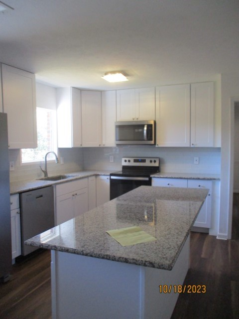 6120 Miller Road Columbus, GA 31907 - Photo 5 of 27 a kitchen with granite countertop a sink a stove and cabinets