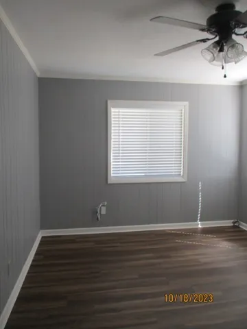 a view of a room with wooden floor and windows