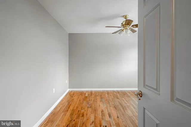 a view of a room with wooden floor and window