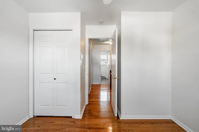 a view of a room with wooden floor