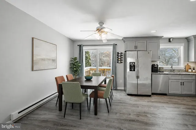 a view of a dining room with furniture large window and wooden floor