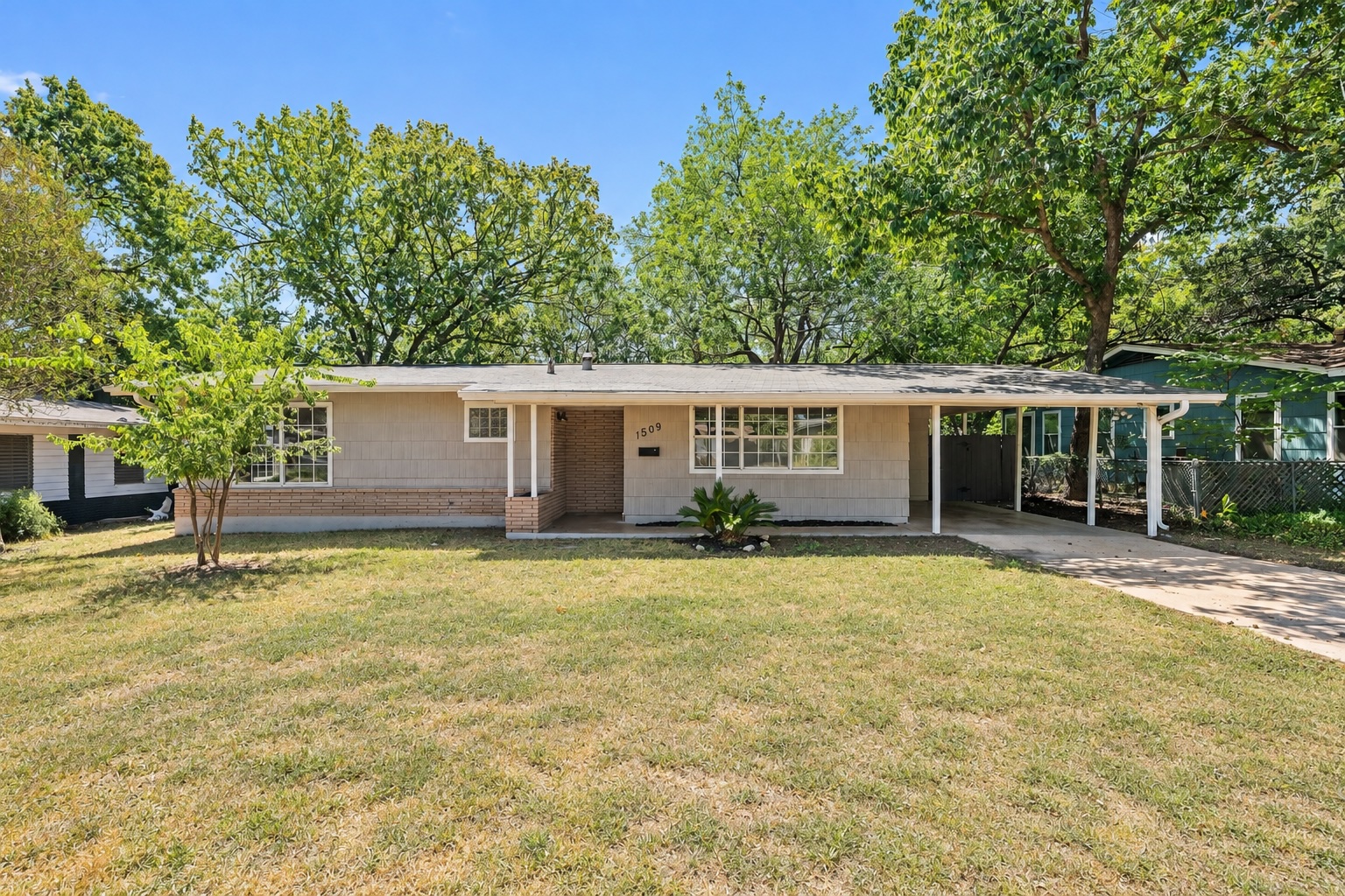 1509 Ridgemont Drive Austin, TX 78723 - Photo 1 of 28 Front of home with covered carport and front porch (Slightly enhanced image)