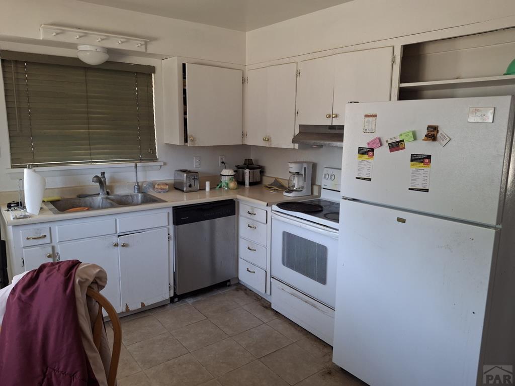 214 3rd Street Fowler, CO 81039 - Photo 6 of 15 a kitchen with white cabinets and white appliances