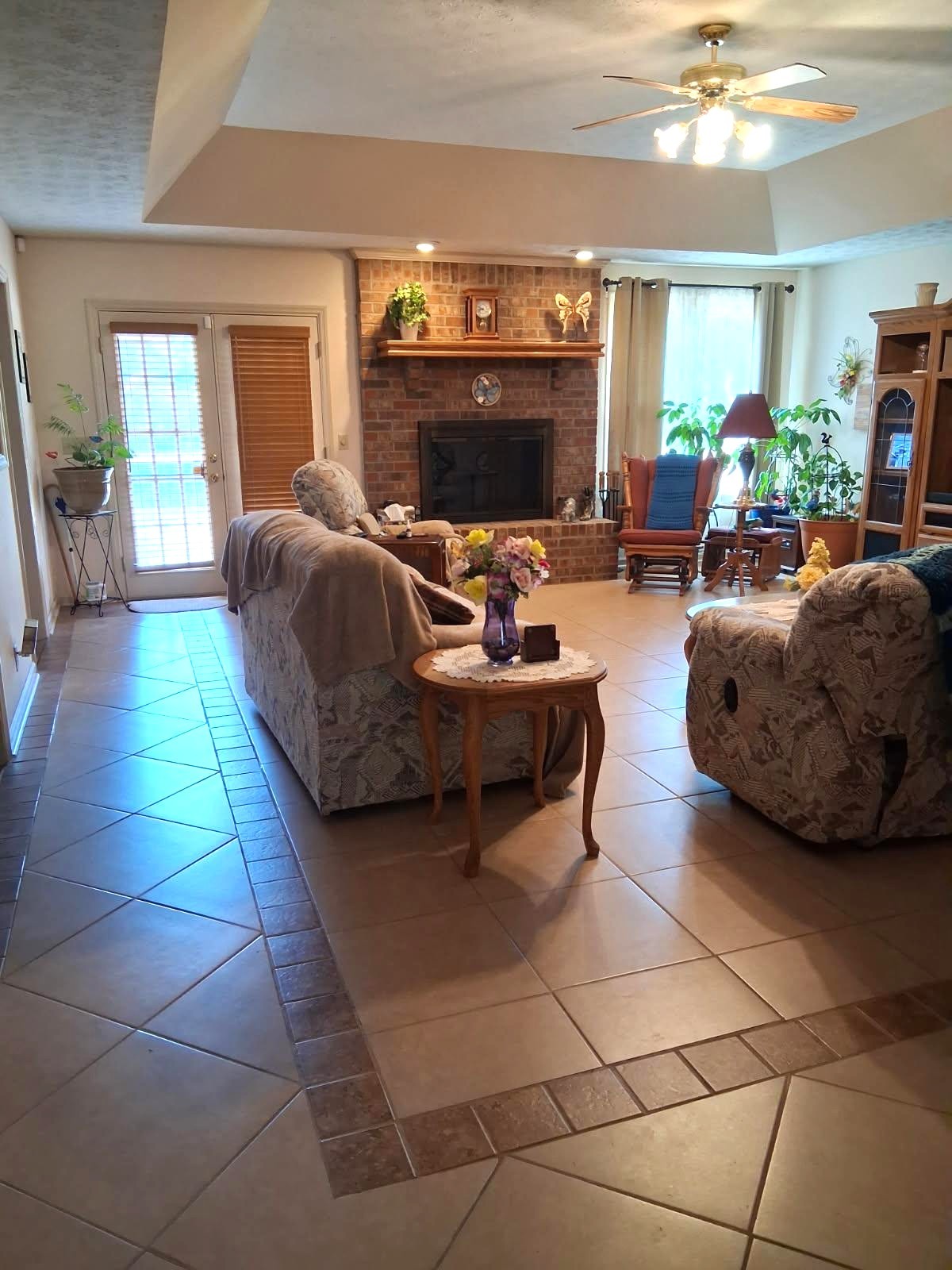 3168 Maxey Road Cedar Hill, TN 37032 - Photo 20 of 40 a living room with furniture a fireplace and a chandelier