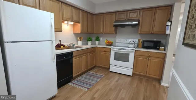 a kitchen with a white stove top oven and refrigerator