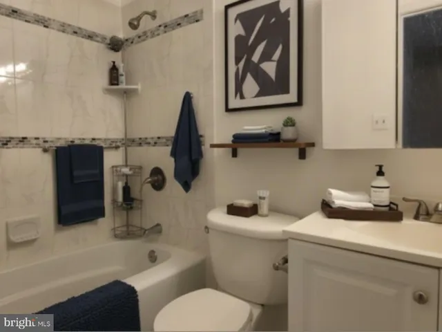 a bathroom with a toilet a sink and bathtub