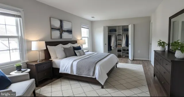 a bedroom with a bed and a potted plant