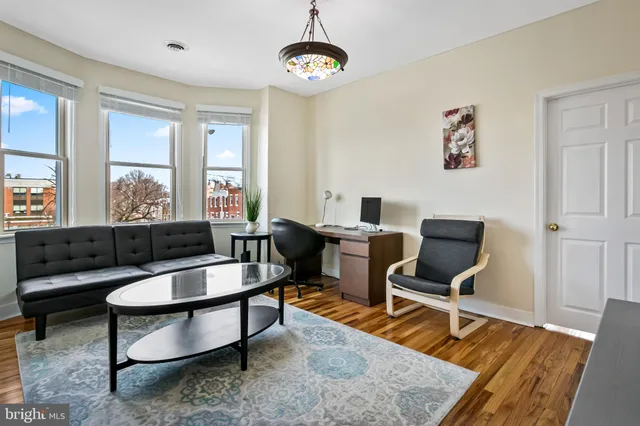a living room with furniture rug and a window