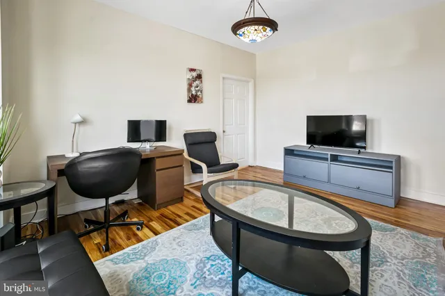 a bathroom with a granite countertop sink toilet a mirror and a window