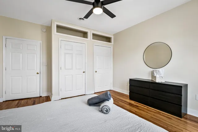 a bed room with a bed and a ceiling fan