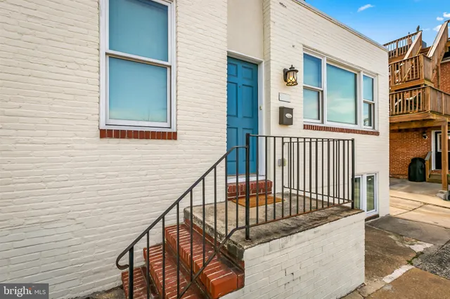 a kitchen with a sink cabinets stainless steel appliances and a window