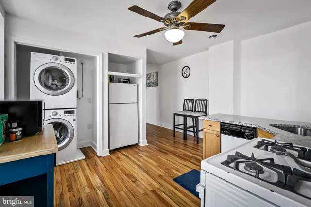 a kitchen with stainless steel appliances granite countertop a sink a stove and a refrigerator