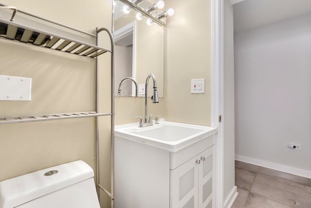 3604 West George Street, Unit G Chicago, IL 60618 - Photo 15 of 19 a bathroom with a sink a toilet and shower