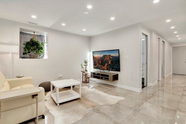 3604 West George Street, Unit G Chicago, IL 60618 - Photo 18 of 19 a living room with furniture and a flat screen tv