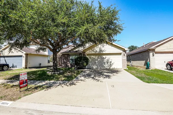a view of a house with a tree in the background