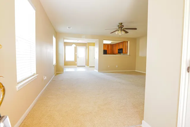 a view of a room with a windows and a ceiling fan