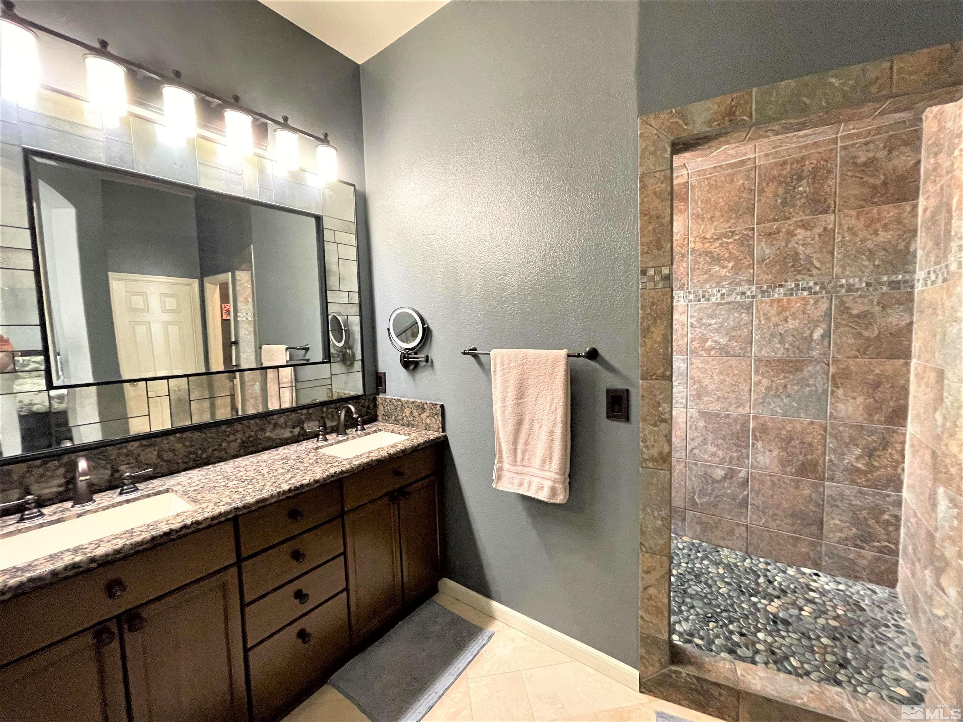 1710 Canyonlands Way Reno, NV 89521 - Photo 21 of 28 a bathroom with a double vanity sink mirror and shower