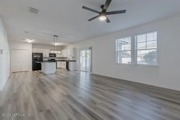 a view of a kitchen with a microwave and a window
