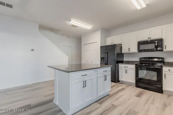 a kitchen with stainless steel appliances a refrigerator stove and sink