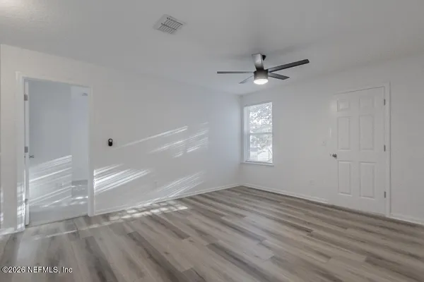 wooden floor in an empty room with a window