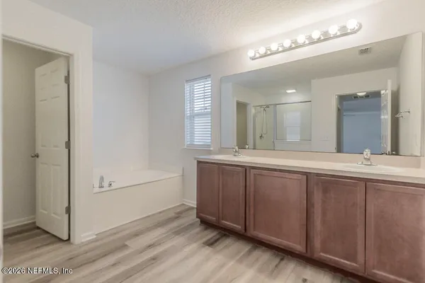 a bathroom with a double vanity sink and a mirror