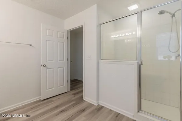 a bathroom with a glass shower door