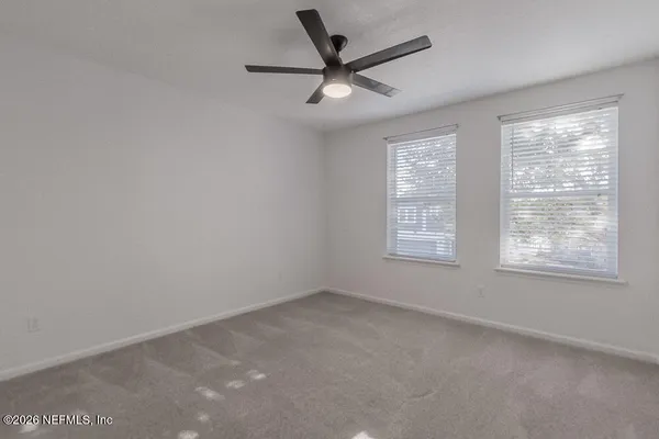 a view of a livingroom with a ceiling fan and window