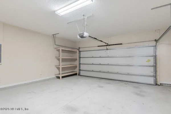 a view of an empty room with a cabinet