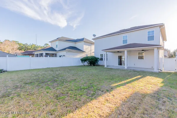 a view of a house with a backyard