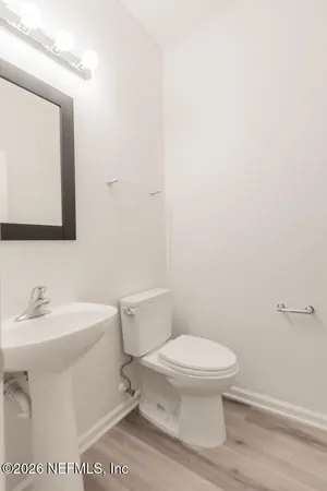 a white toilet sitting next to a bathroom sink