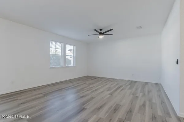 wooden floor in an empty room with a window