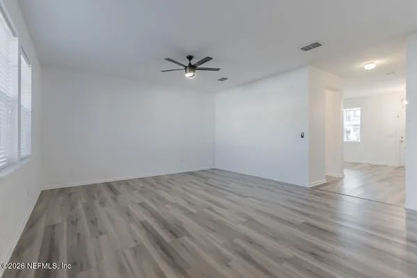 wooden floor in an empty room with a window