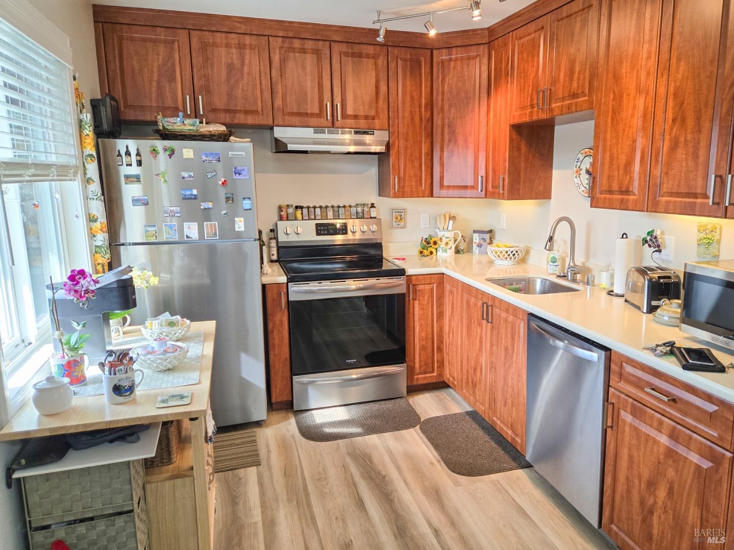 8020 Beverly Drive Rohnert Park, CA 94928 - Photo 22 of 35 a kitchen with granite countertop a sink stove and cabinets