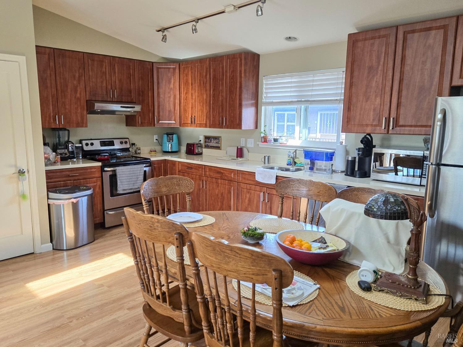 8020 Beverly Drive Rohnert Park, CA 94928 - Photo 25 of 35 a kitchen with granite countertop a dining table and chairs